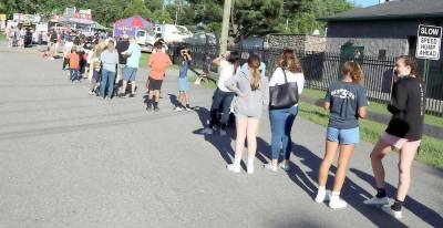 On opening day, record crowds lined up to purchase tickets and wristbands. Photos by Roger Gavan.