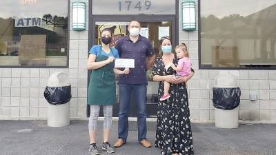 On July 28, Stephen Kitar, owner of Sam’s Meat Warehouse in the Village of Florida, presented a check for $2,000 to Carmela Borrazas, founder of Hugs for Courage. From left, Uliana Kitar, her father, Stephen Kitar, and Carmela Borrazas, cofounder of Hugs for Courage, with her daughter Penelope. Photo by Terry Gavan.