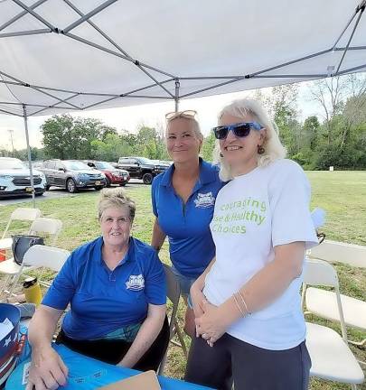 Greeting &amp; registering people at the entrance of the event for ‘National Night Out’ (from left) are: Warwick Valley Coalition members Judy Quackenbush, Youth Coordinator Kerry M. Demetroules and Director of Prevention Services Annie Colonna.