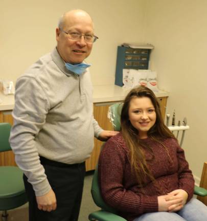 2. Dr. Vincent Margherita, DDS, whose practice is in Orthodontics, discusses orthodontic options with Carley Klein, 13, on Kids Dental Health Day..