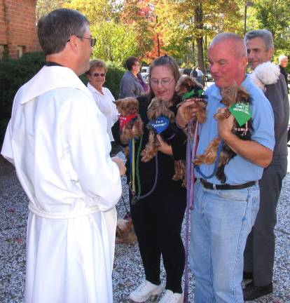 Photos by Roger Gavan Jack and Lynne Koval presented their four Yorkshire Terriers: Ceile, Callahan, Shannon and Gretchen for a blessing by Rev. Michael McLoughlin, pastor of the Church of St. Stephen, the First Martyr. (Gretchen was named after Lynne Koval&#xfe;&#xc4;&#xf4;s first dog and missed out on an Irish name.