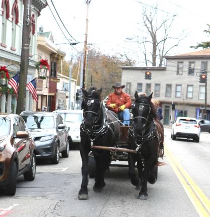 Sean Giery and his team of Percherons, Jack and Bob, were in the Village again with their mascot &#x201c;Butch,&#x201d; who enjoys riding shotgun. And visitors bundled up and took advantage throughout the day of the free horse and buggy rides traveling through the Village.