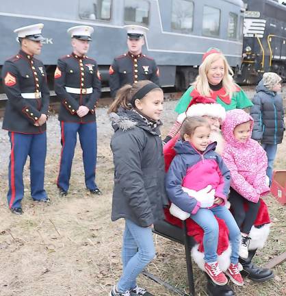 Santa was also on board with the elves and a Marine Corps detachment. They spent almost an hour posing for photographs with children and families.