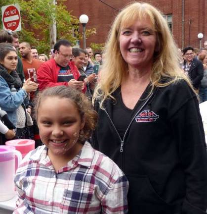 Winner of the youth Pie Eating Contest, Kaylin Marichal of Howard Beach, finished her small apple pie in 2:10. She is congratulated by Leslie Noble of Noble Pies.