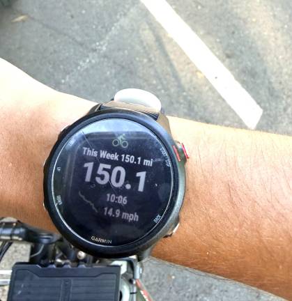 Aaron Archibald showing off his fitness tracker highlighting his 150-mile bike ride completed by cycling the Goshen to Harriman trail multiple times.