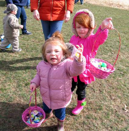Success! Maeve Ahearn, 2, and her cousin Makayla Ahearn, 3, show off their full baskets.