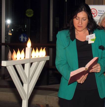 An invocation and blessing of the tree by Director of Pastoral Care Suzanne Evanoff.