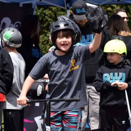 Gavin Donaldson celebrates after winning the scooter Open Jam Session for competitors 10 and Under at the Do It For Dale Skate Contest.