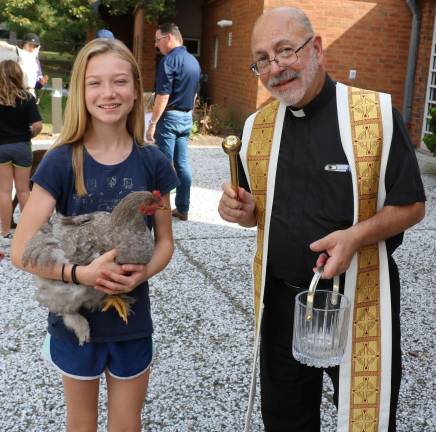 Grace Margiewicz, 11, brought her pet chicken, &quot;Fade,&quot; to be blessed.