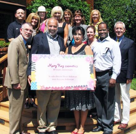 Photo by Roger Gavan On Aug 16, Warwick public and business representatives joined Sherry Bukovcan and her husband, Milosh, to celebrate her 30th anniversary with Mary Kay Cosmetics. Front from left, Town of Warwick Supervisor Michael Sweeton, Milosh and Sherry Bukovcan, Cedric Glasper, president of the Warwick Valley Chamber of Commerce, and Michael Johndrow, executive director of the Chamber. Other members of the Warwick Valley Chamber of Commerce also joined in the celebration.