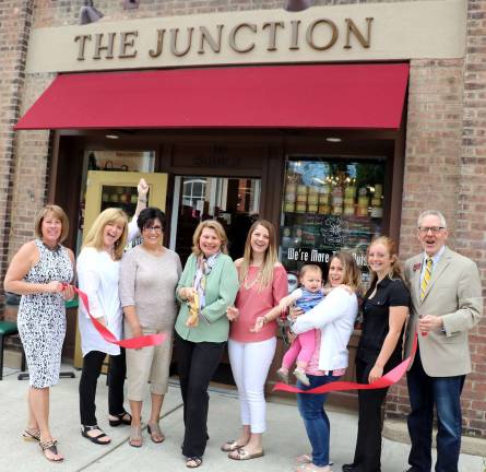 Photo by Roger Gavan On Thursday, June 8, members of the Warwick Valley Chamber of Commerce joined co-owner Annette DiZenzo (center) and members of her family to celebrate the first year anniversary of The Junction at 16 Railroad Ave, in the Village of Warwick.