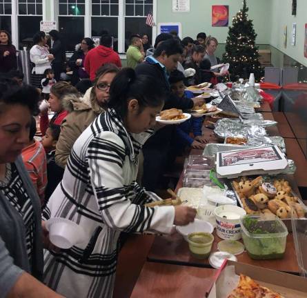 Everyone gathered in the St. Stephen-St. Edward School cafeteria for traditional homemade foods, which everyone brought, including tamales, atoles, tostaditos and otherl foods for the feast day.