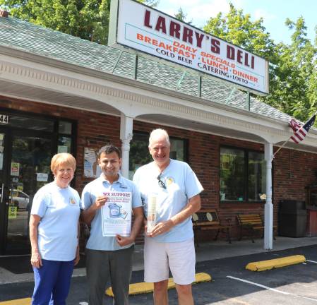 Larry's Deli has always been a big supporter. Backpack Snack Attack President Shirley Puett and volunteer Len Singer pose with.Larry's Deli owner Ronak Patel (center).
