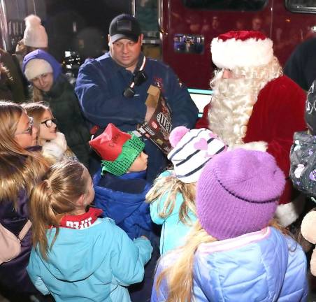 And once again, Santa, traveling in a modern fire apparatus, made his usual early surprise visit and handed out goodies to the excited children who lined up to greet him.