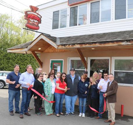 Photo by Roger Gavan On May 7, Town of Warwick Supervisor Michael Sweeton (right), Greenwood Lake Mayor Jesse Dwyer (left) and members of both the Warwick Valley and Greenwood Lake Chambers of Commerce joined owners David and Yolanda Kozuha (center), their friends and relatives for a ribbon-cutting ceremony to celebrate the occasion.