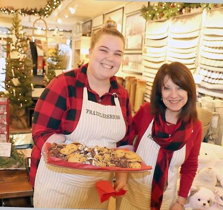 From left, Frazzleberries sales associate Maggie Kemp and owner Marybeth Schlichting served special holiday treats to their customers.