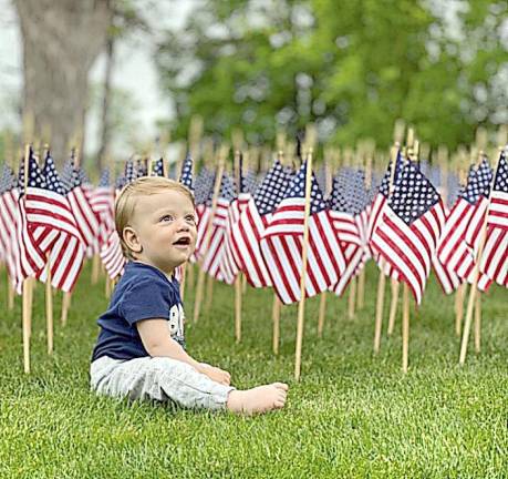 Ryan Hasbrouck of Warwick, almost 1 years old, enjoying the flags. I think that picture really reflects hope, said Cindy Vander Plaat, something we all need.