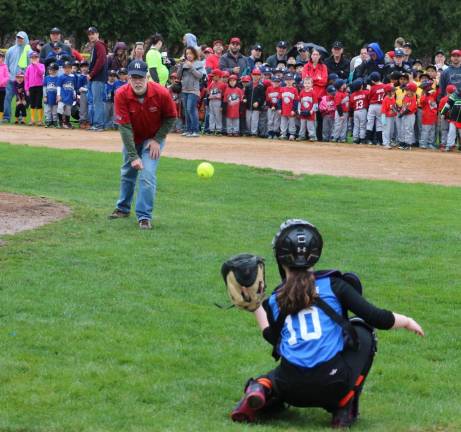 Little League opening day ceremony. Supervisor Sweeton tosses out the first softball to catcher Annie Lincoln.