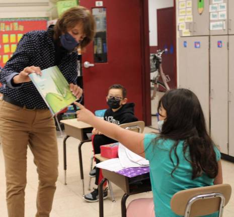Throughout the reading, the students pointed out things on the pages as Golden Hill Principal Debbi Lisack held up the open book while she read. These sharp second-grade students in Michael Hoyt’s class figured out some clues along the way.