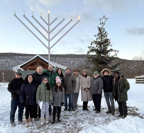 From left: Scott Lewis, Jessica Lewis and their two daughters; Lenny Rosenbaum; Dr. Jared Cohen; Alexa Weingarten; Rabbi Roger Lerner of Monroe Temple; Village Mayor Tom Howley; Village Trustees Thais Pilieri, Matt Veth, John Trazino, and Chad Sellier.