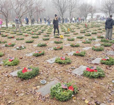 In December, the Warwick Ambulance Junior Corp volunteered in Wreaths Across America at the Orange County Veterans Cemetery in Goshen. The Junior Corp gave a $300 donation to purchase 30 wreaths to be placed on veterans' graves. The Junior Corp member Olivia Maylor stands amidst the graves and wreaths.