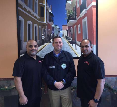 Orange County Executive Steven M. Neuhaus, center, meets with Dos Latinos Restaurant owners Rommel Cartright, left, and Edgar Perez on Monday, Dec. 5.