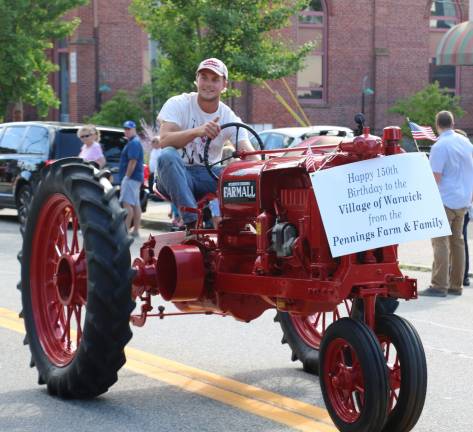 A vintage tractor courtesy of Pennings Farm drives down the parade route.