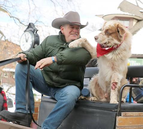 Sean Giery demonstrated that his mascot “Butch,” who enjoys riding shotgun, has learned to wave to the crowd.