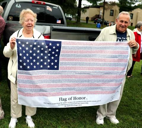 Warwick residents Anita and Pat Colman brought their Flag of Honor, which displayes the names of those who perished in the 9-11 terrorist attack.