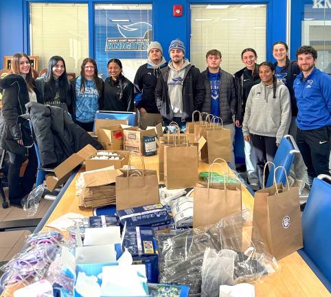 Mount Saint Mary College student-athletes – and Nyla Pichardo ’24, Resource Development Manager at Habitat for Humanity of Greater Newburgh (far left) – assembled care packages containing essential supplies during a service project.