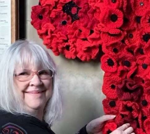 Warwick, New York, native Jill Ayers Moering attaches additional poppies crocheted by her daughter-in-law Brittany Moering.