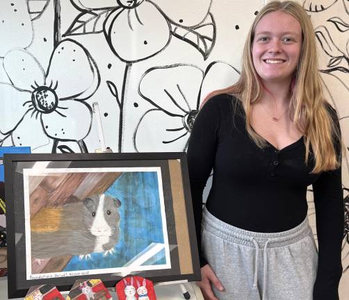 Warwick Valley High School sophomore Allie Wolf with her artwork.