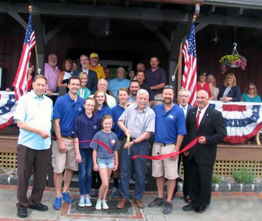 Photo by Roger Gavan On Friday, June 3, local officials and representatives of the Florida and Warwick Chambers of Commerce joined the owners, their families, staff and customers for a ribbon-cutting ceremony to celebrate the grand reopening of Roe Brothers Lumber on Maple Avenue in the Vilalge of Florida. Arnold Bieling (center), flanked by his sons and co-owners Scott (left) and Tim (right) and their families, cuts the ribbon held by Florida Mayor James Pawliczek (far left) and Town of Warwick Deputy Supervisor James Gerstner (far right.)