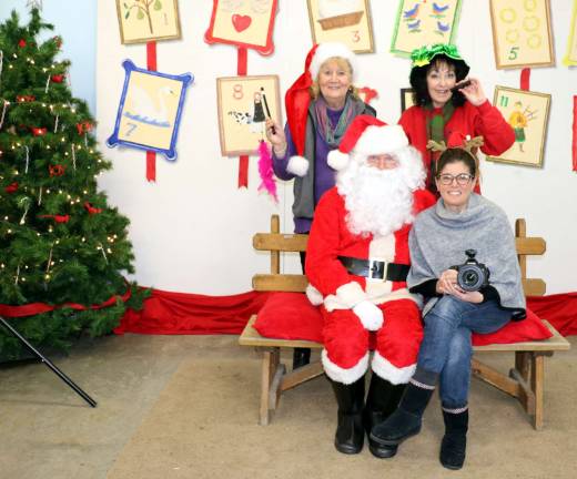 &quot;Santa's helpers&quot; on the &quot;Pet Photos with Santa&quot; set: Rear from left, Warwick Valley Humane Society Vice President Celia Ross and Suzyn Barron, president of the Society do whatever it takes to make each pet pose. Front from left, Santa and photographer Kimberly Standish.