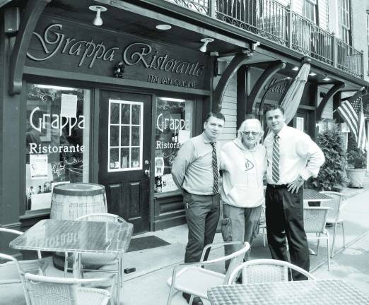 Hosts Nick Ahmetaj (left) and Tony Sylaj (far right) of Grappa Ristorante and coordinators George Laurence (center) and Kevin Ege (not available for the photo) have just completed booking for the 10th season of Railroad Avenue's Music in the Courtyard series.