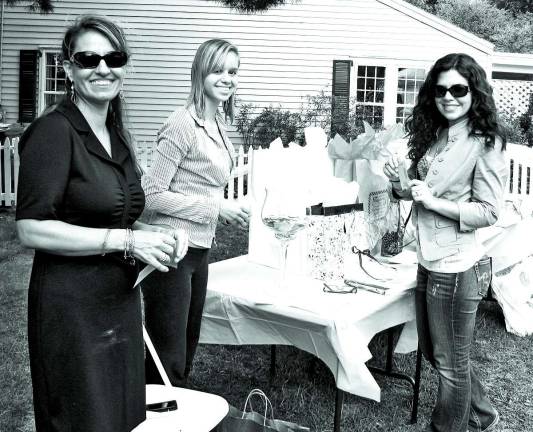 From left, Bridal Trail Chair Nicole Repose and volunteer Heather Storms enter bride-to-be Bianca Ruiz in a raffle for numerous prizes donated by participating merchants.