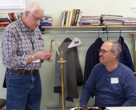 Bob Berkowitz (a.k.a Fix-It-Bob) tackles a lamp under the watchful eye of fellow coach Tom Bonita, who read about the Hudson Valley Repair Cafes in a New York Times article and drove from New Jersey to volunteer.