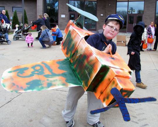 Additional photos can be found online at warwickadvertiser.com Patrick Cernuto, 10, demonstrates a coordinated turn with the airplane he designed and made from boxes and other scraps. An aviation enthusiast, Patrick can name and explain the function of each part of the plane.