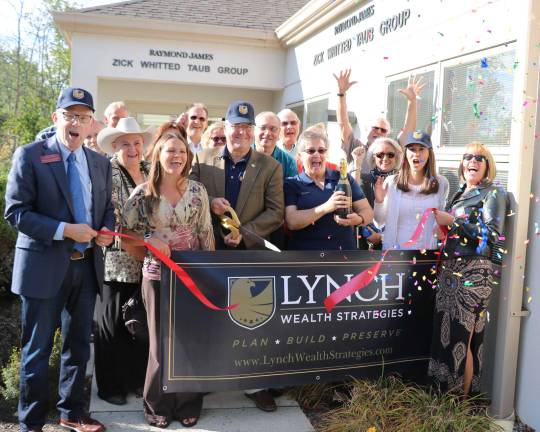 Photo by Roger Gavan On Sept. 28, members of the Warwick Valley Chamber of Commerce joined Ed Lynch, president of Lynch Wealth Strategies, and his wife, Susan, (center) along with staff, relatives, clients and friends for a ribbon-cutting ceremony to celebrate Lunch&#x2019;s three-year anniversary in independent practice as well as 14 years as a financial advisor.