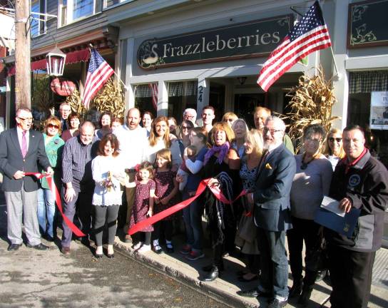 Photo by Roger Gavan On Thursday, Nov. 3, state, town and village public officials, along with members of the Warwick Valley Chamber of Commerce, joined Tim and MaryBeth Schlichting, Jerry and Katie Schlichting and their children Libby, 7, and Ellie, 5, (center area at ribbon cutting), staff and friends to celebrate Frazzleberries 20th anniversary.