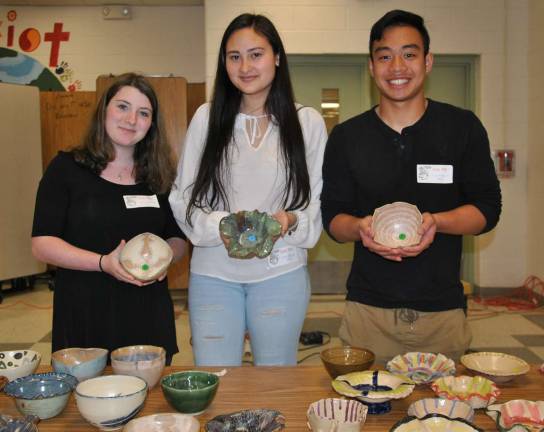 WVHS Empty Bowls Club members show some of the hundreds of beautiful bowls made and donated by local potters and students for this fund raiser.