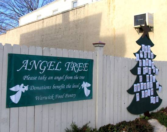 Photo by Roger Gaven The traditional Angel Tree, encouraging gifts for the needy, is again displayed on Main St. between Akin's Drug Store and Newhard's Gift Shop.