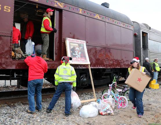 Volunteers helped load the train with gifts that had been collected locally during the holiday season.