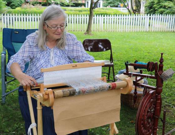 Craft exhibits at the community celebration included a spinning demonstration by Susan Logothetis.