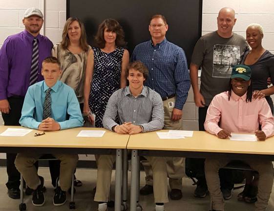 Photo provided by Warwick Valley Athletic Department Three Warwick senior football player signed National Letters of Commitment for the fall of 2017. Pictured from left to right with their parents are: Gene Decker, with Gene and Lisa Decker; Nick Parchinksi, with Kendra and Ken Parchinksi; and Tyler Wiliams with Chris Gill and Monica Williams.