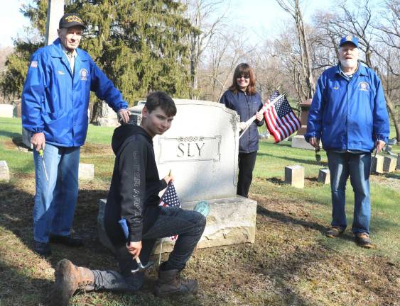 Patricia Rodrigues and her son Joey, a member of Troop 45, worked with veterans Warren Mc Farland (left) and Walter Parkinson. The grave site in the photograph is that of Civil War veteran Norman Sly.