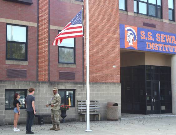 JROTC instructor Michael Washington with two JROTC cadets as S.S. Seward Institute.
