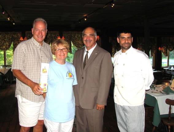 Restaurants, like the Landmark Inn, will use envelopes with information about the program and fundraiser that will accompany a patron's check at the end of the meal. From left, Back Pack Snack Attack volunteer Len Singer holding a coin drop container, President Shirley Puett, Town of Warwick Deputy Supervisor James Gerstner and Michael DiMartino, chef/owner of the Landmark Inn.