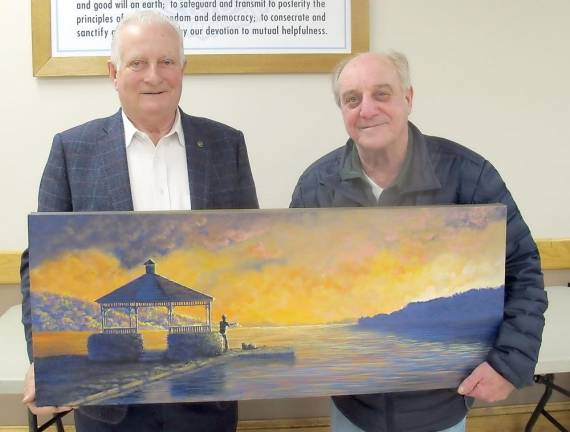 Tom Mulchay, the commander of the Greenwood Lake American Legion, presents a painting by local artist Chris Vanvoren to Carl LaMarca of Greenwood Lake. The painting was a winning raffle prize.