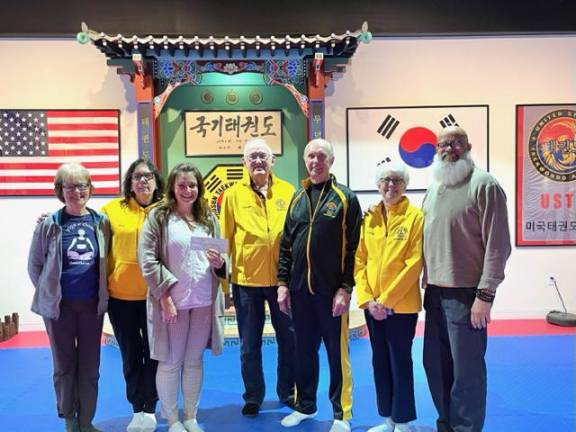 Chosun Taekwondo Academy owners and Warwick Lions Club officers.